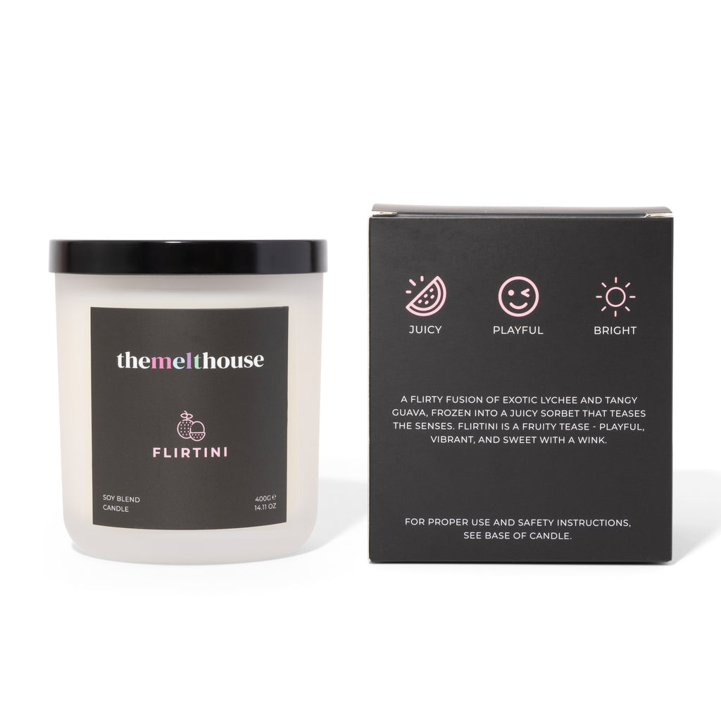 Candle labeled 'themelthouse' with packaging on a white background