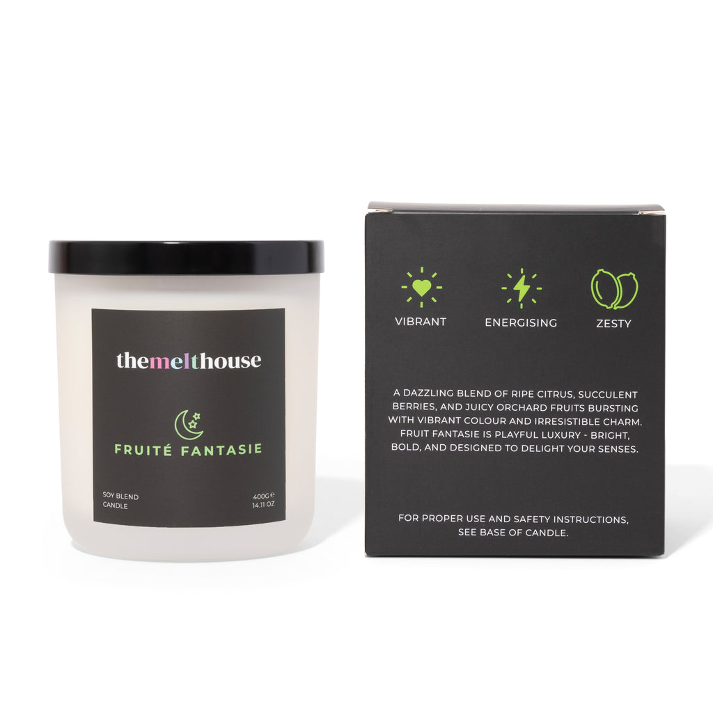 Candle labeled 'Fruite Fantasie' by themelthouse with its packaging on a white background