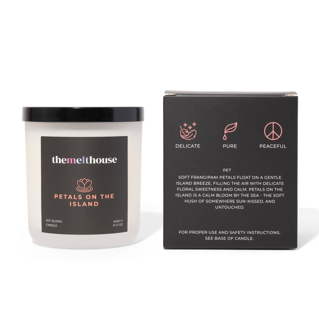 Candle labeled 'themelthouse' with packaging on a white background