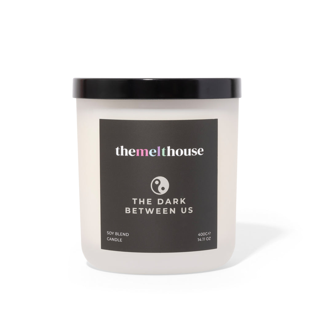 Candle with 'themelthouse' label on a white background